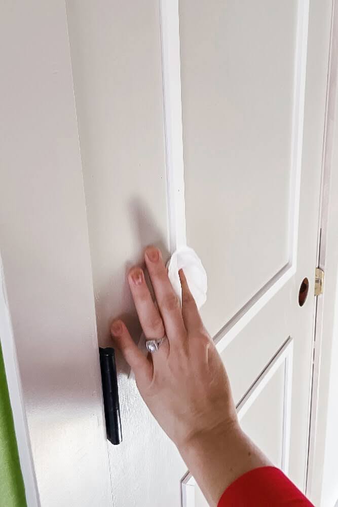 using a baby wipe to clean up caulking around door trim seams