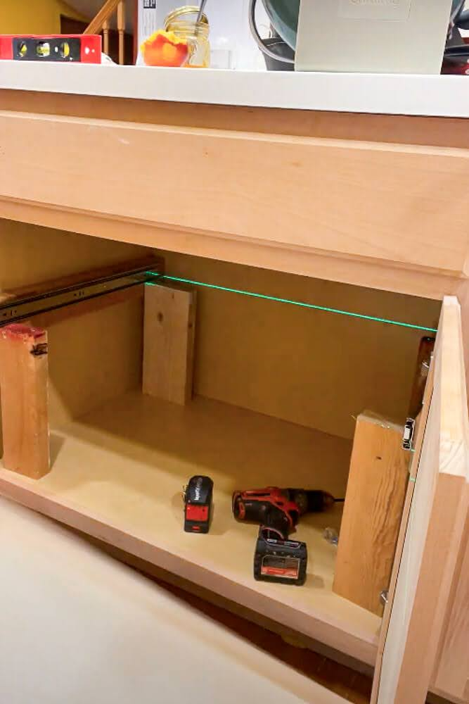 supports set up with laser level for cabinet drawer