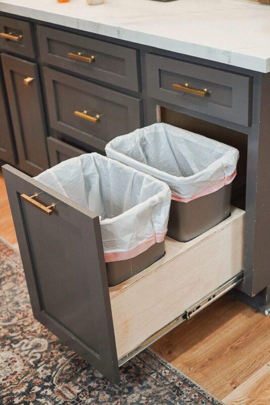 Left side view of pull-out trash drawer cabinet with two trash bins