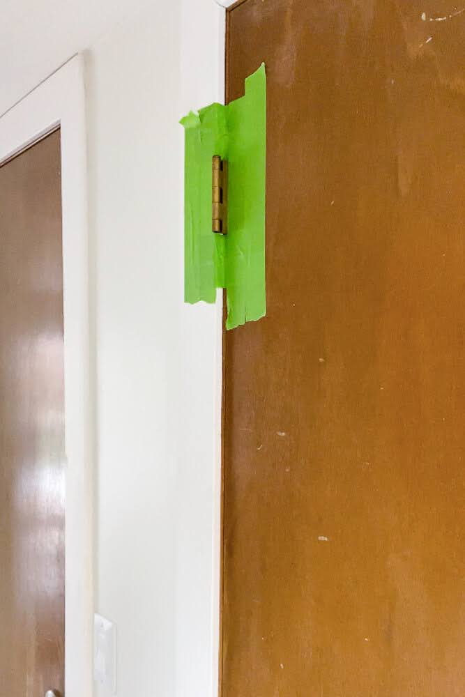 taped door hinges ready for paint in diy closet door makeover