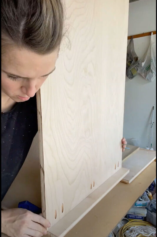 Woman building a cabinet with pocket holes.