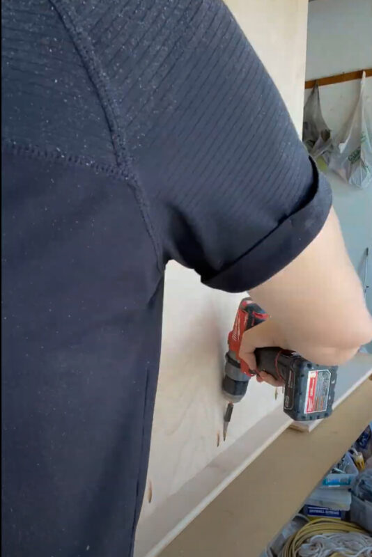 Woman using a drill.