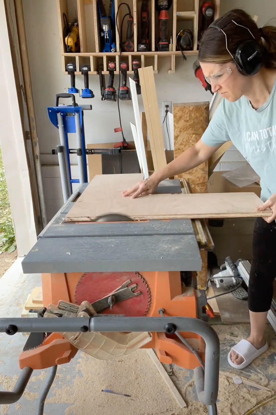 Woman using a table saw.