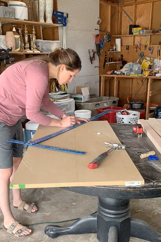 Woman using a T square to measure oval on MDF