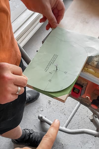 Murphy bed template lined up on board showing exact location for curved cut detail