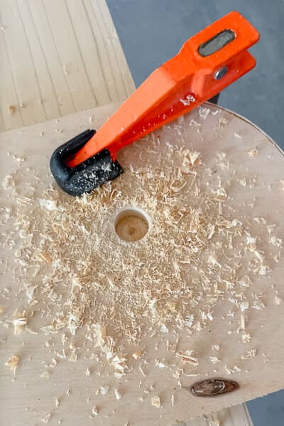 Forstner bit and drill clamp on plywood board