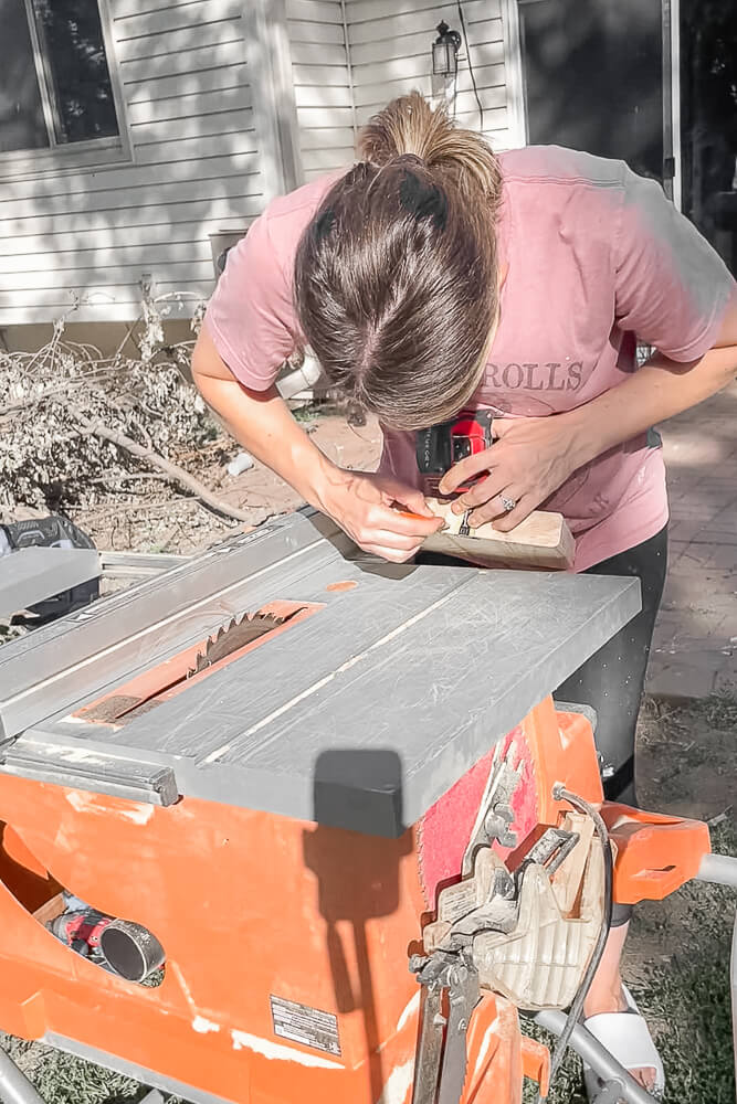 woman cutting wood for a knife block
