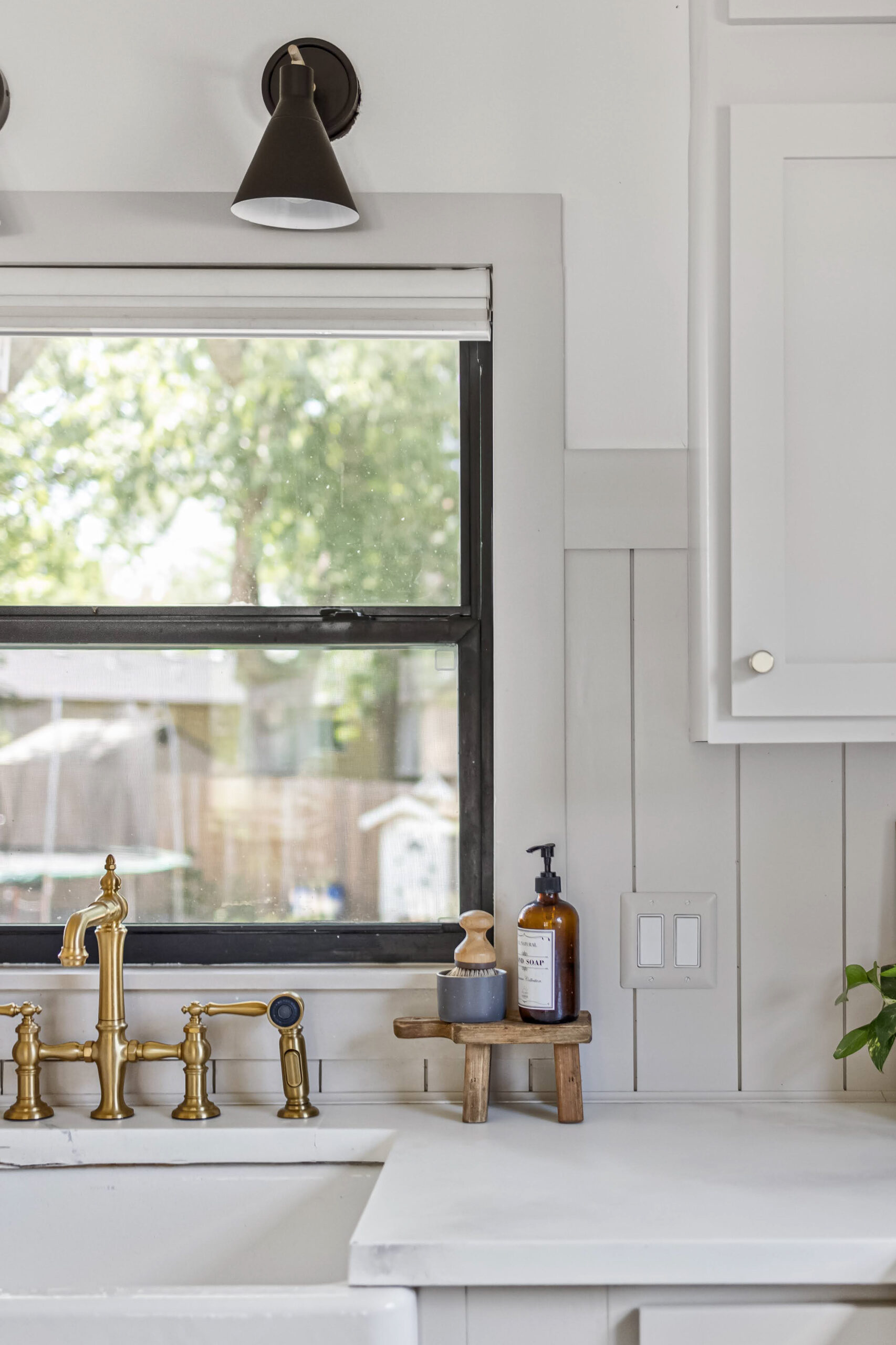 Windows painted black in a gorgeous, fully renovated kitchen.