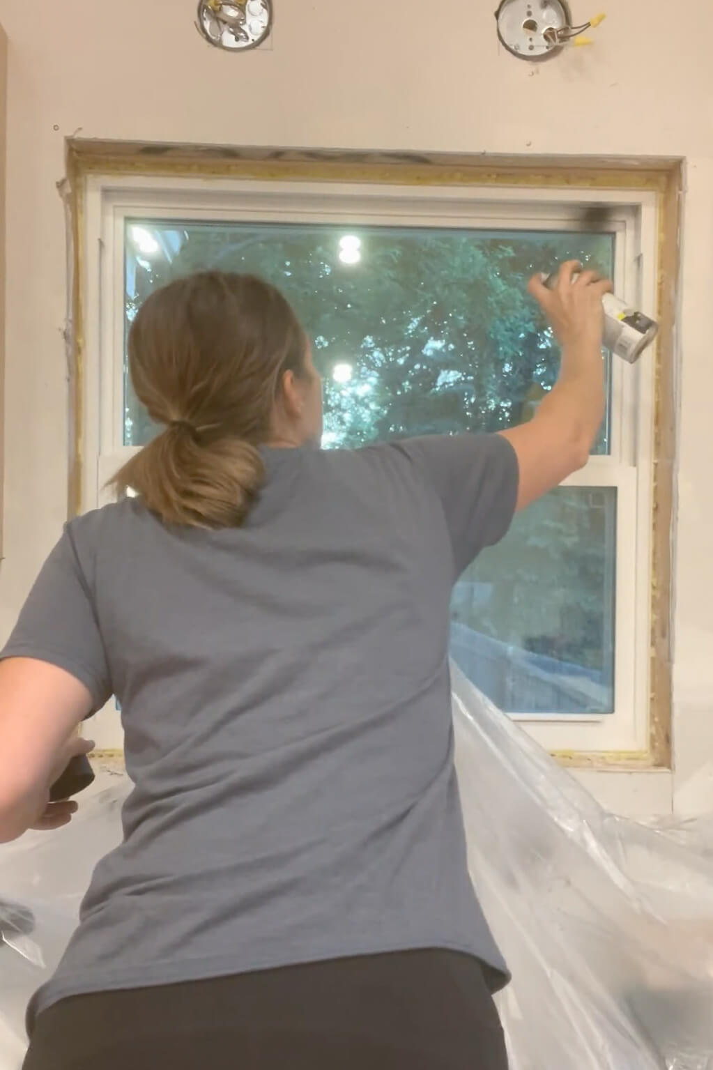 Using spray paint to change windows from white to black.