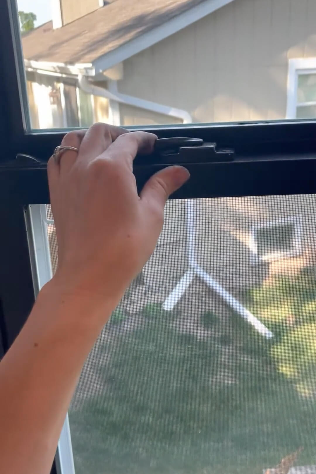A window frame that has been painted completely black with spray paint.