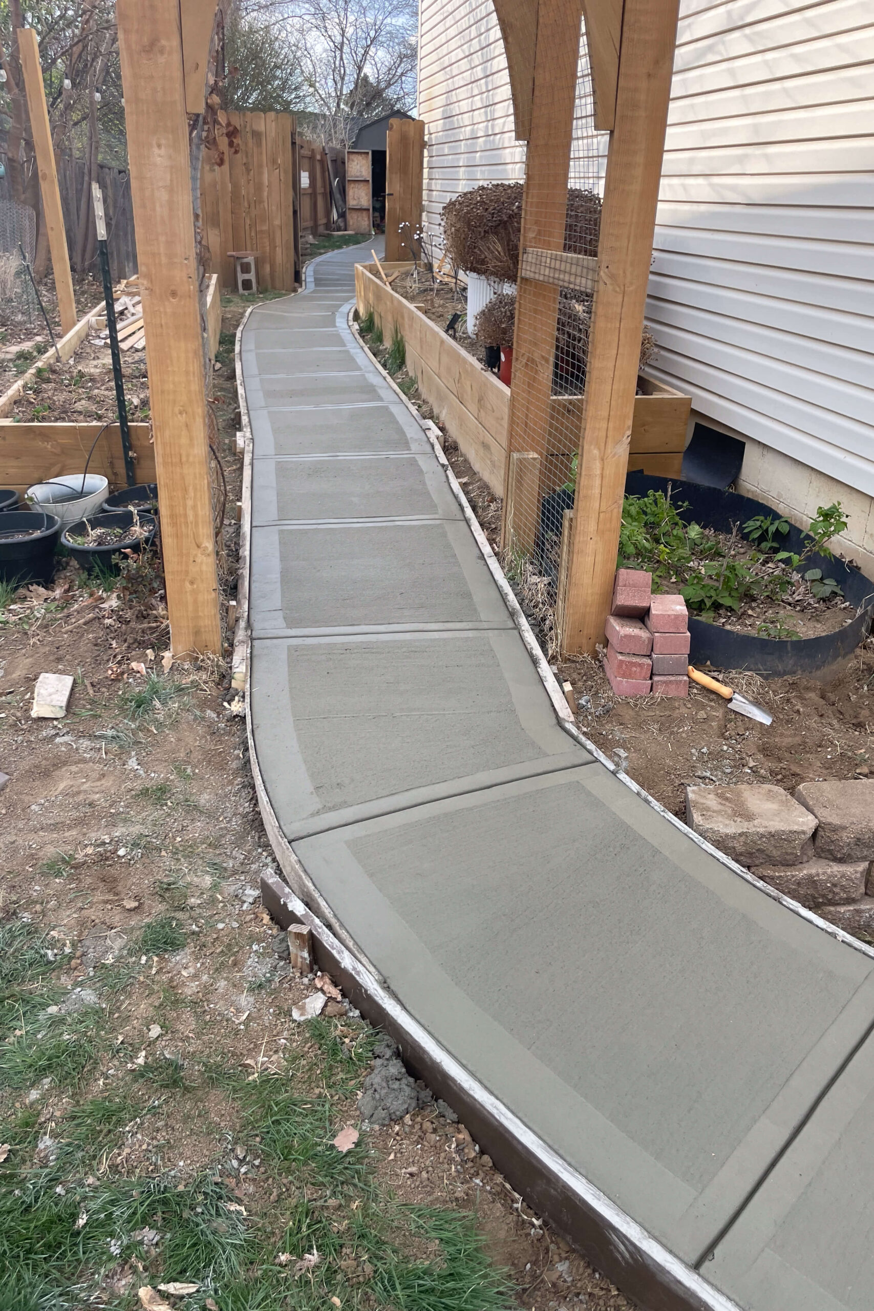 Finished concrete sidewalk done by workers I hired from facebook marketplace.