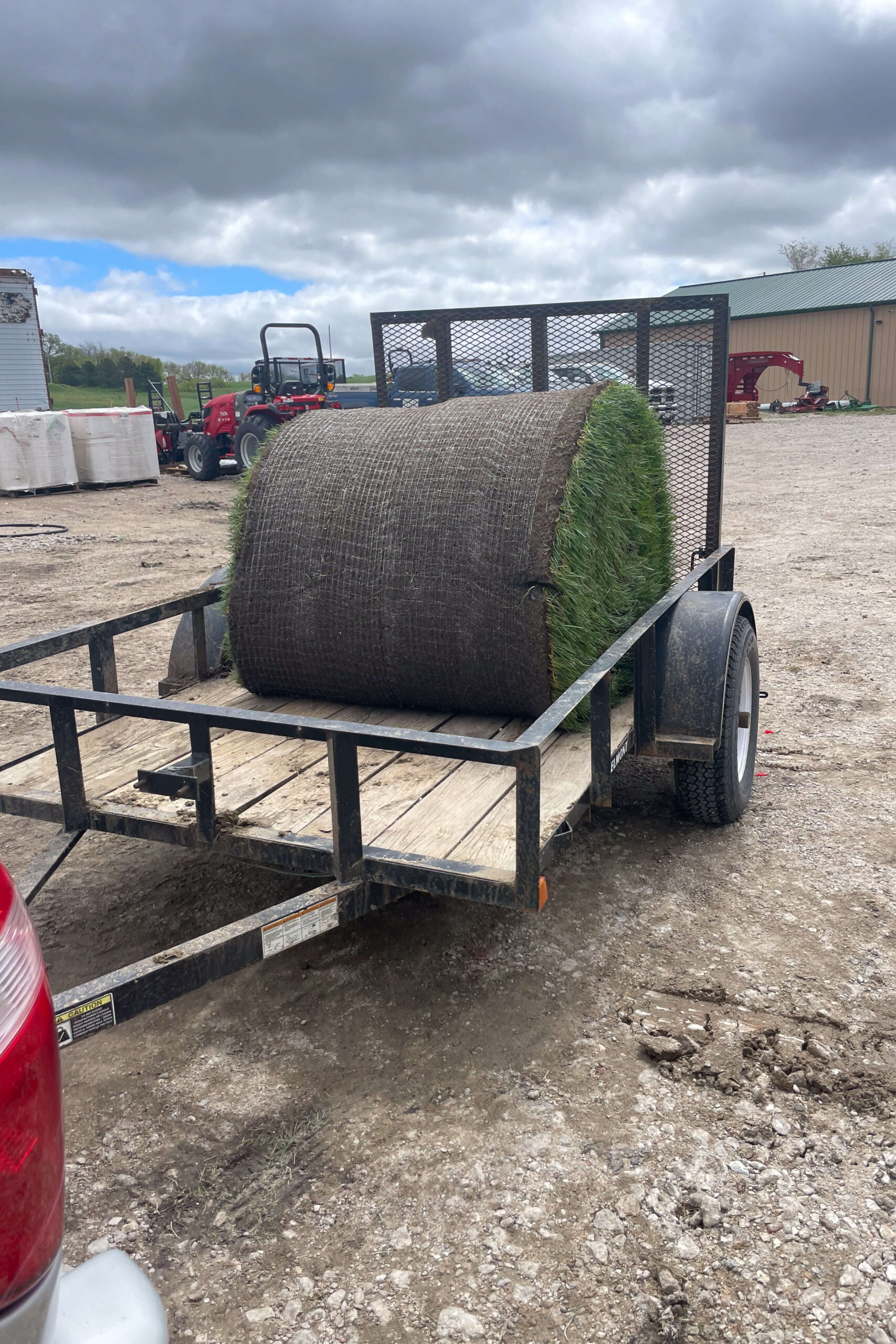 Picking up a giant roll of sod in a trailer. 