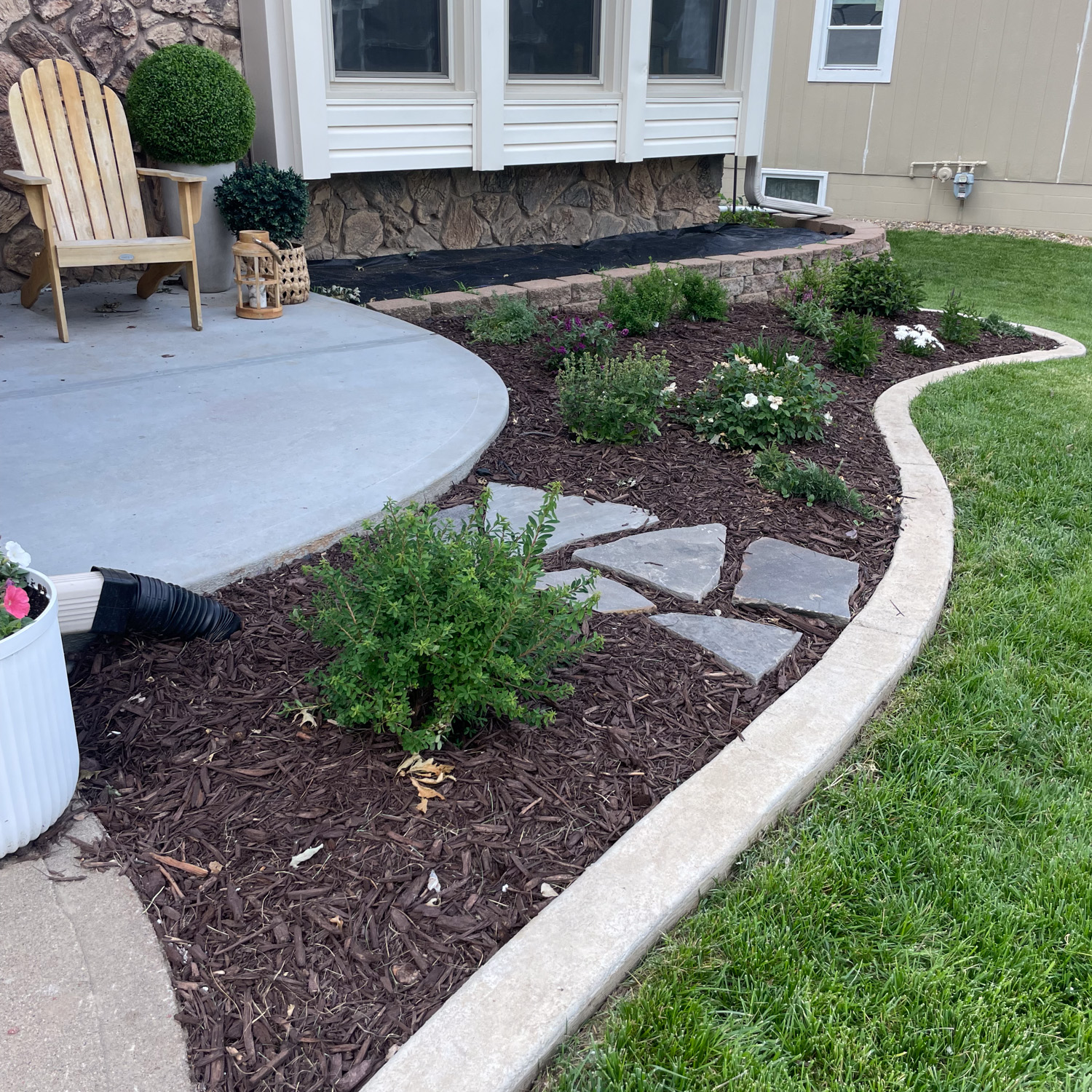 Gorgeous DIY cement curbing in front yard landscaping.