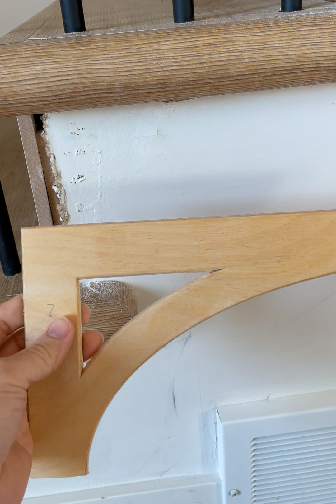 Using a stair bracket to finish DIY stair install.