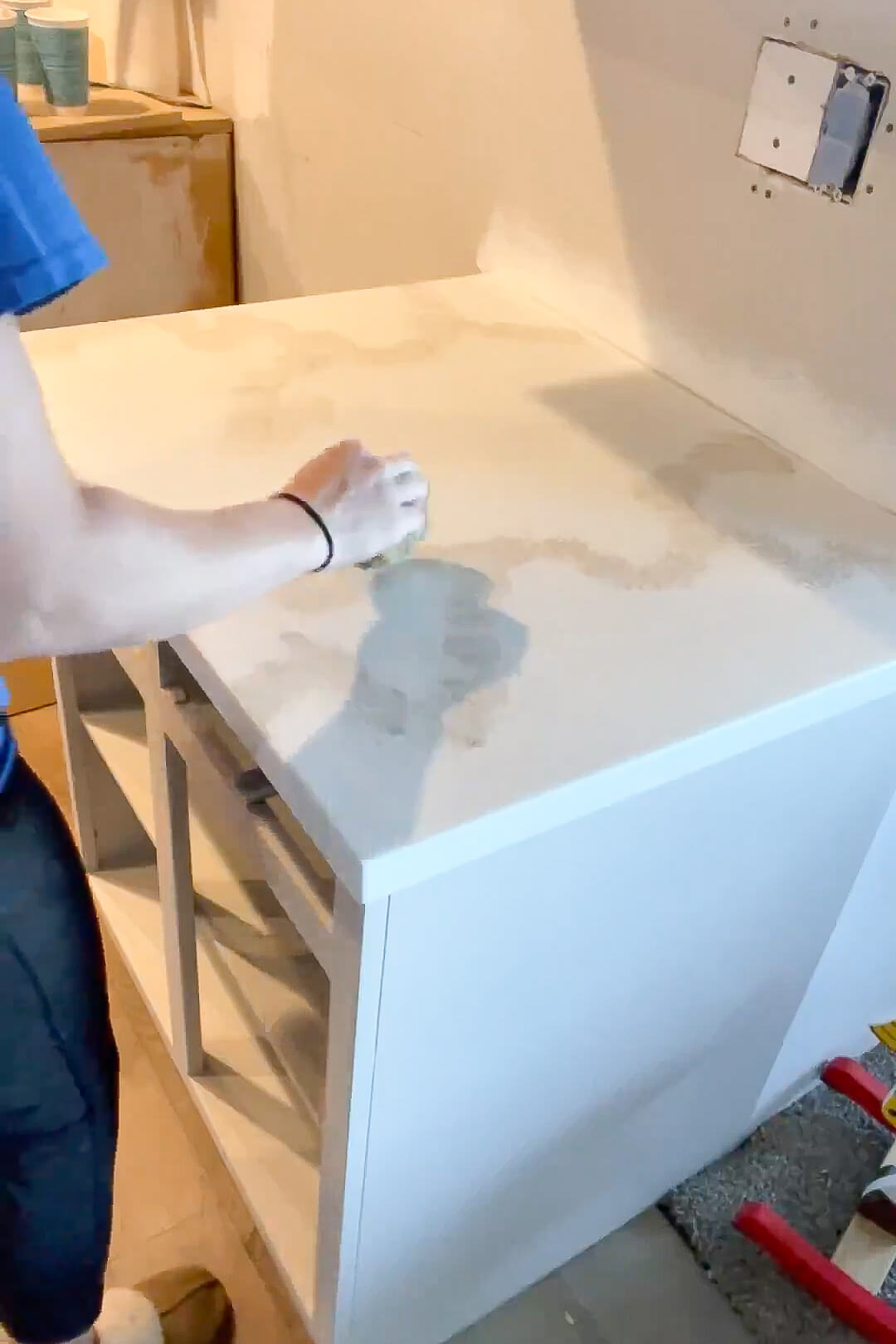 Painting a countertop for a faux marble finish. 