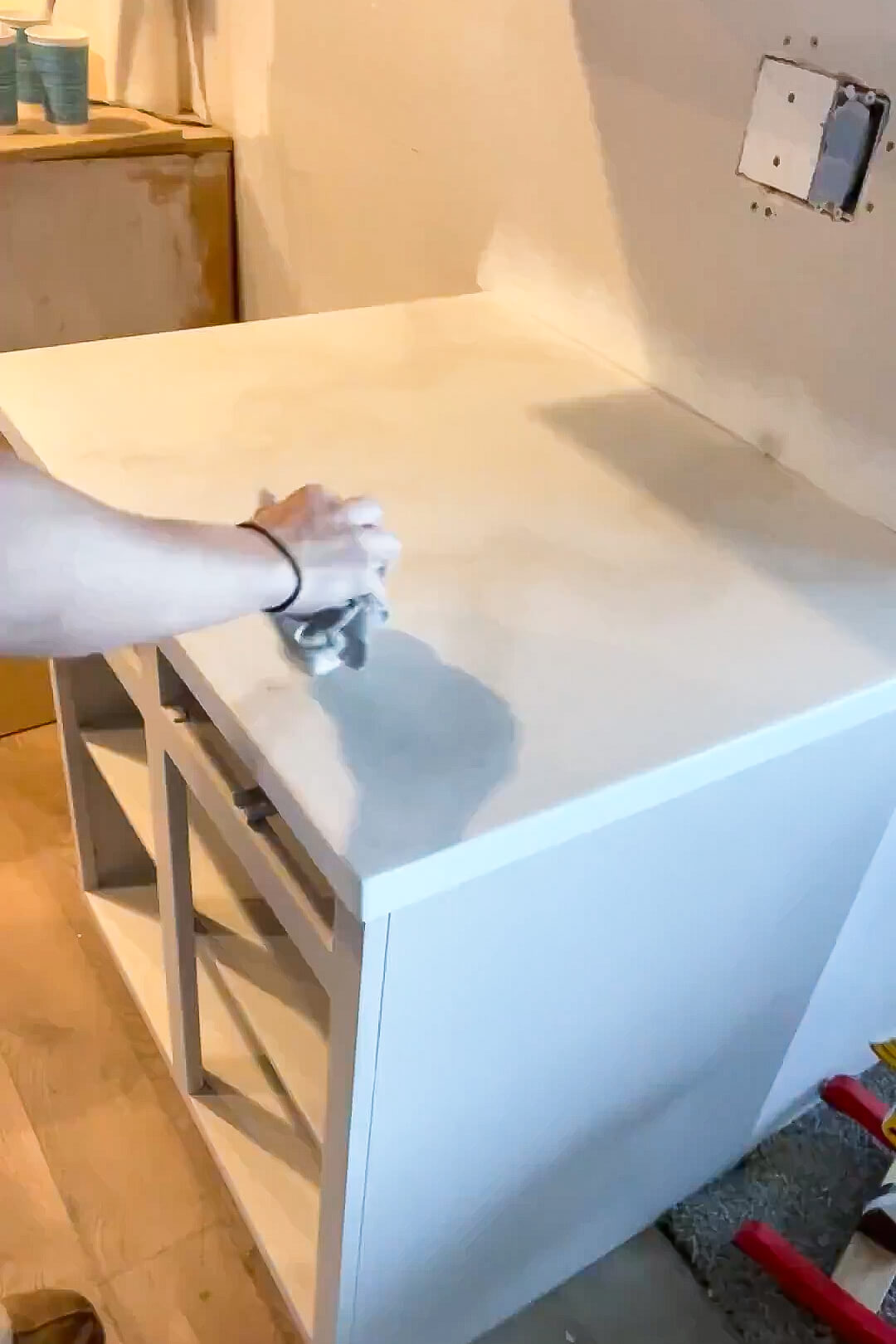 Painting a countertop for a faux marble finish.