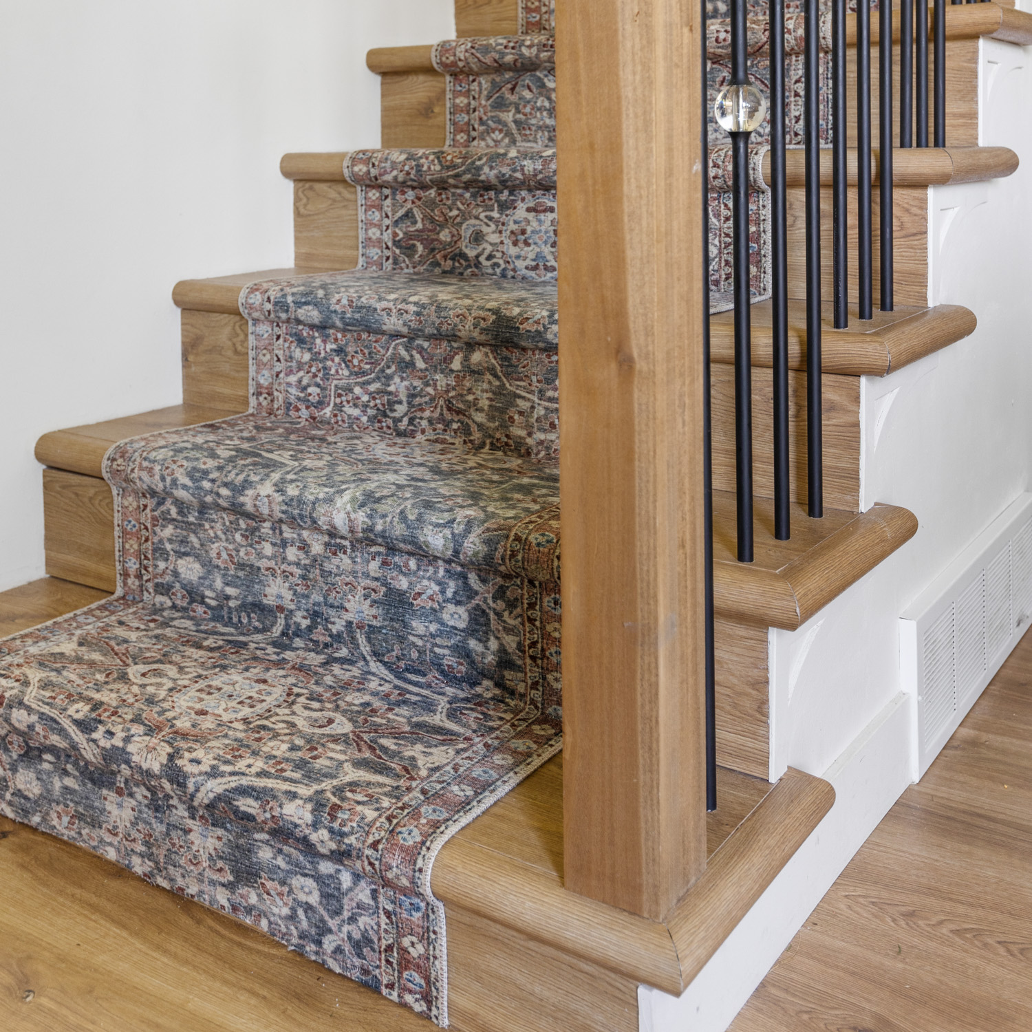 After picture of a DIY stair runner installation.