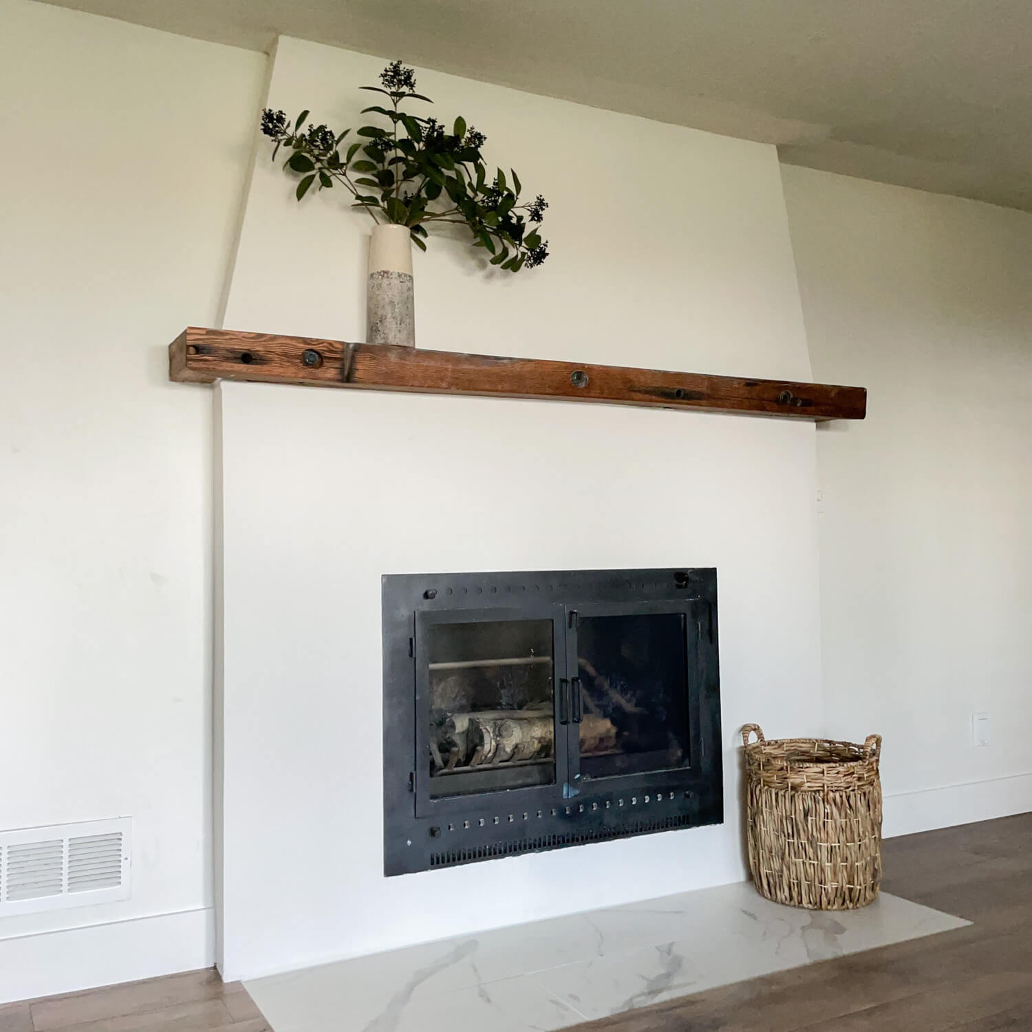 After picture of a DIY stone fireplace makeover with a modern fireplace with a Spanish vibe.