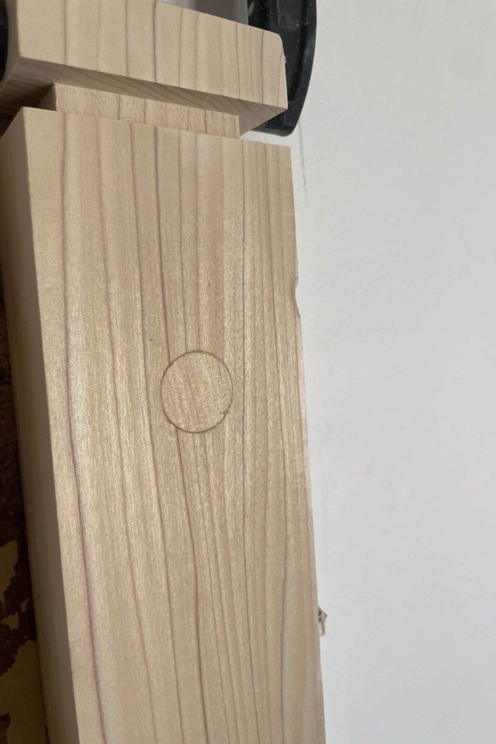 A plugged hole from installing a newel post against the wall. 