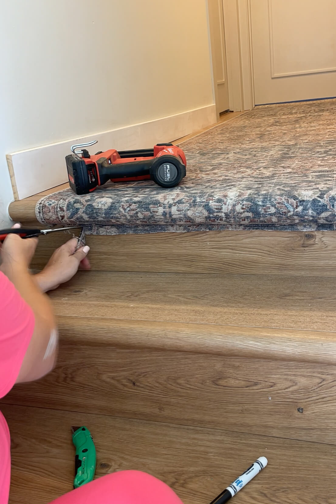 Trimming extra carpet off while installing a stair runner. 