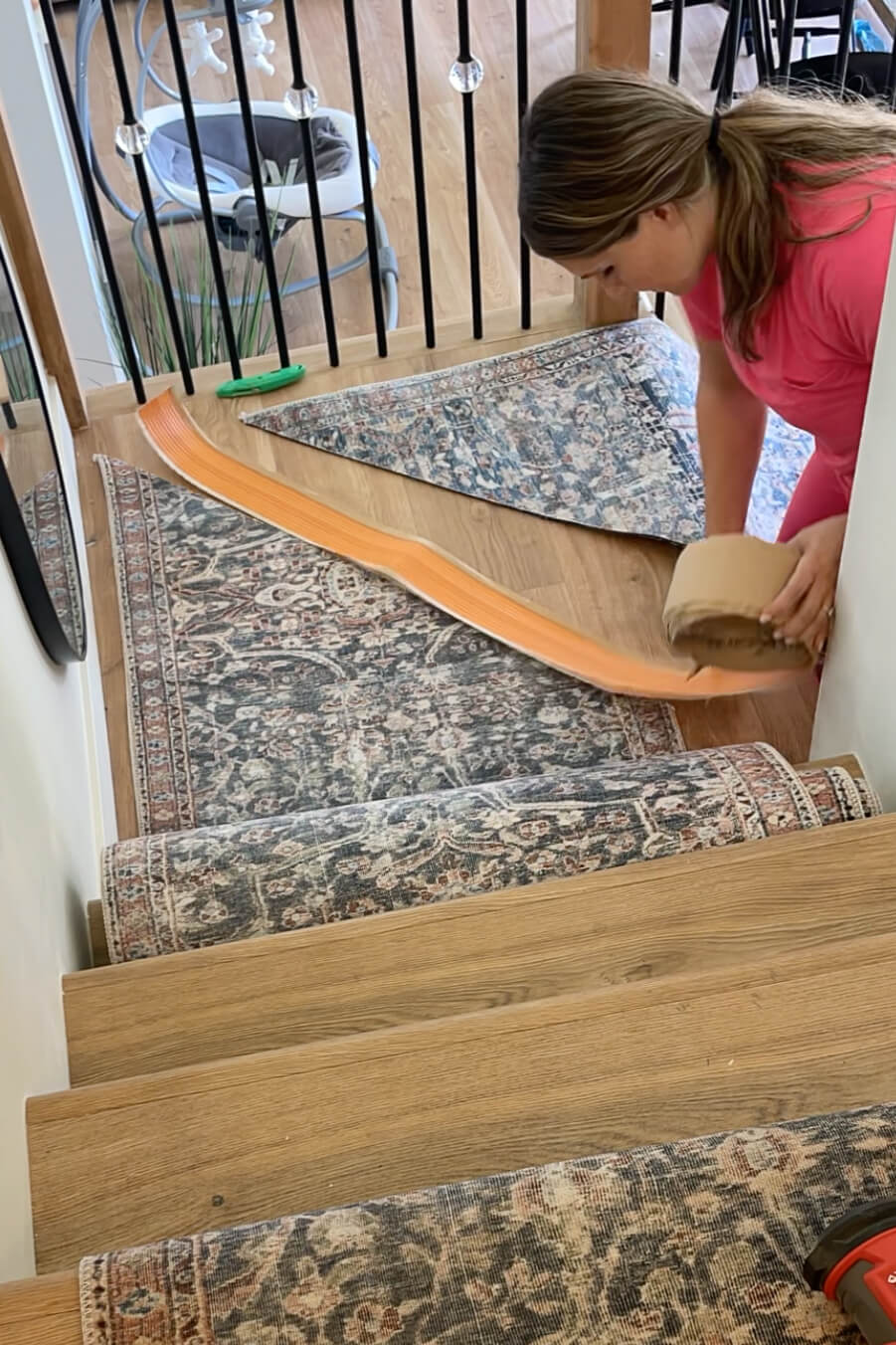 Using iron on carpet tape to attach two pieces of a carpet runner. 