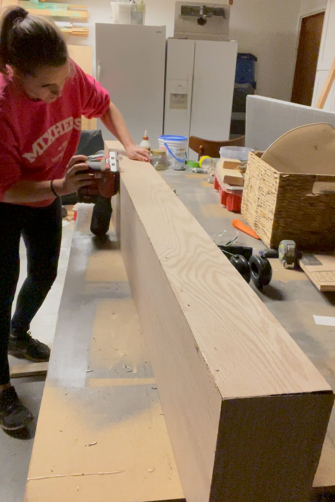 Sanding a DIY fireplace mantle.