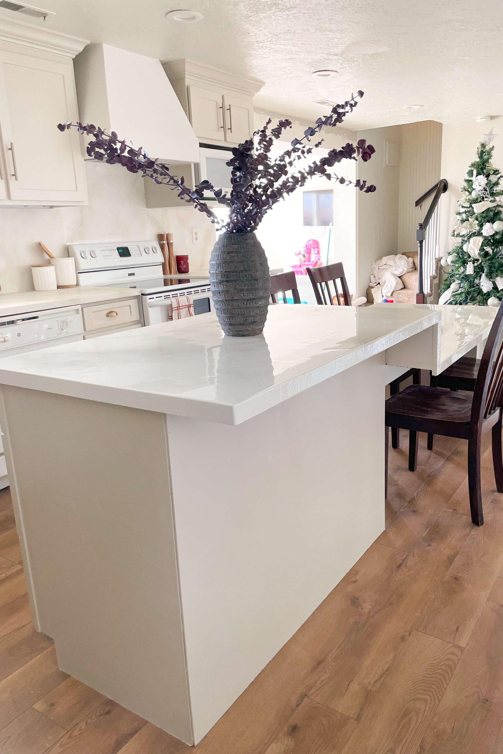 DIY built kitchen island with a waterfall edge countertop.