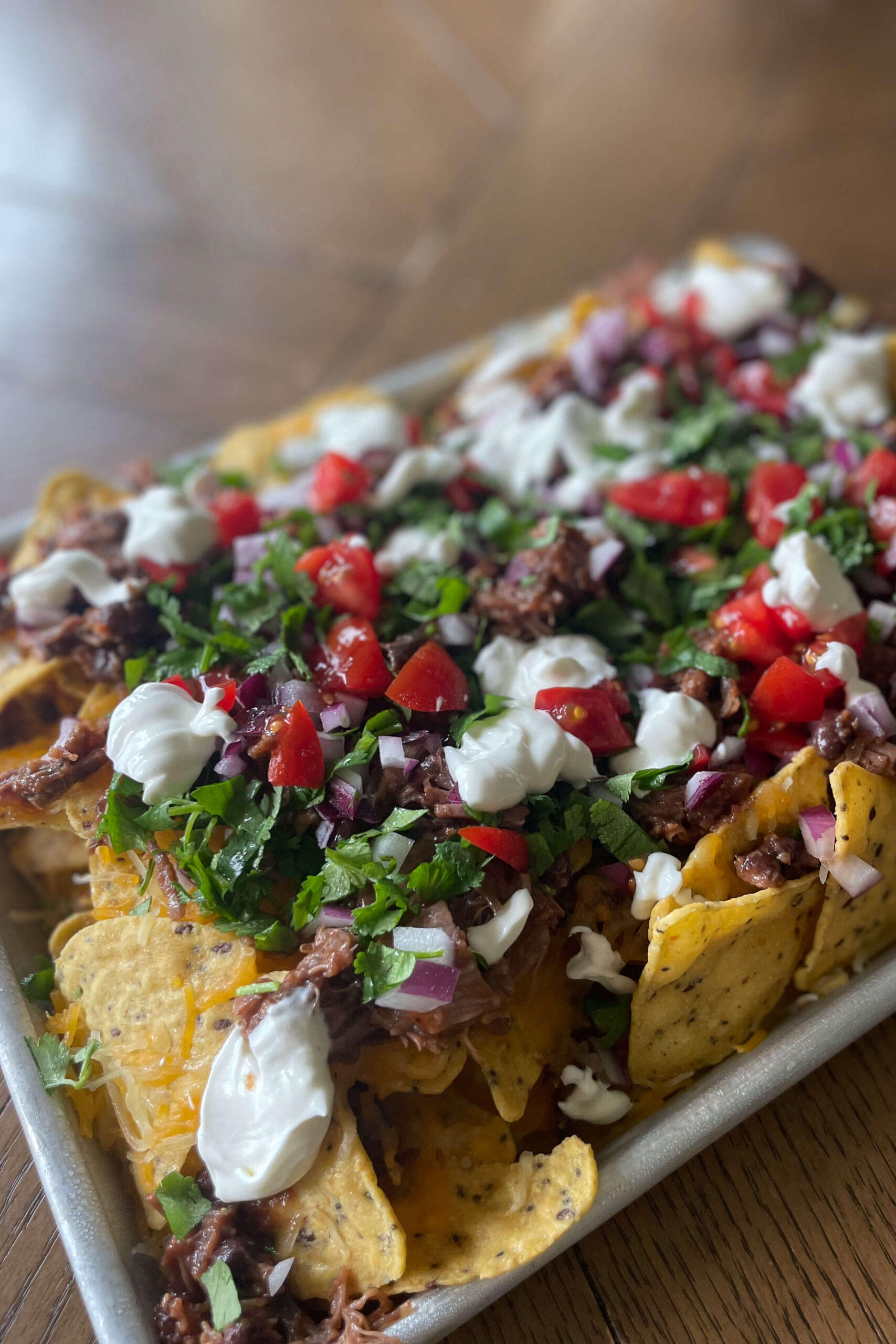 Finished picture of delicious brisket nachos.