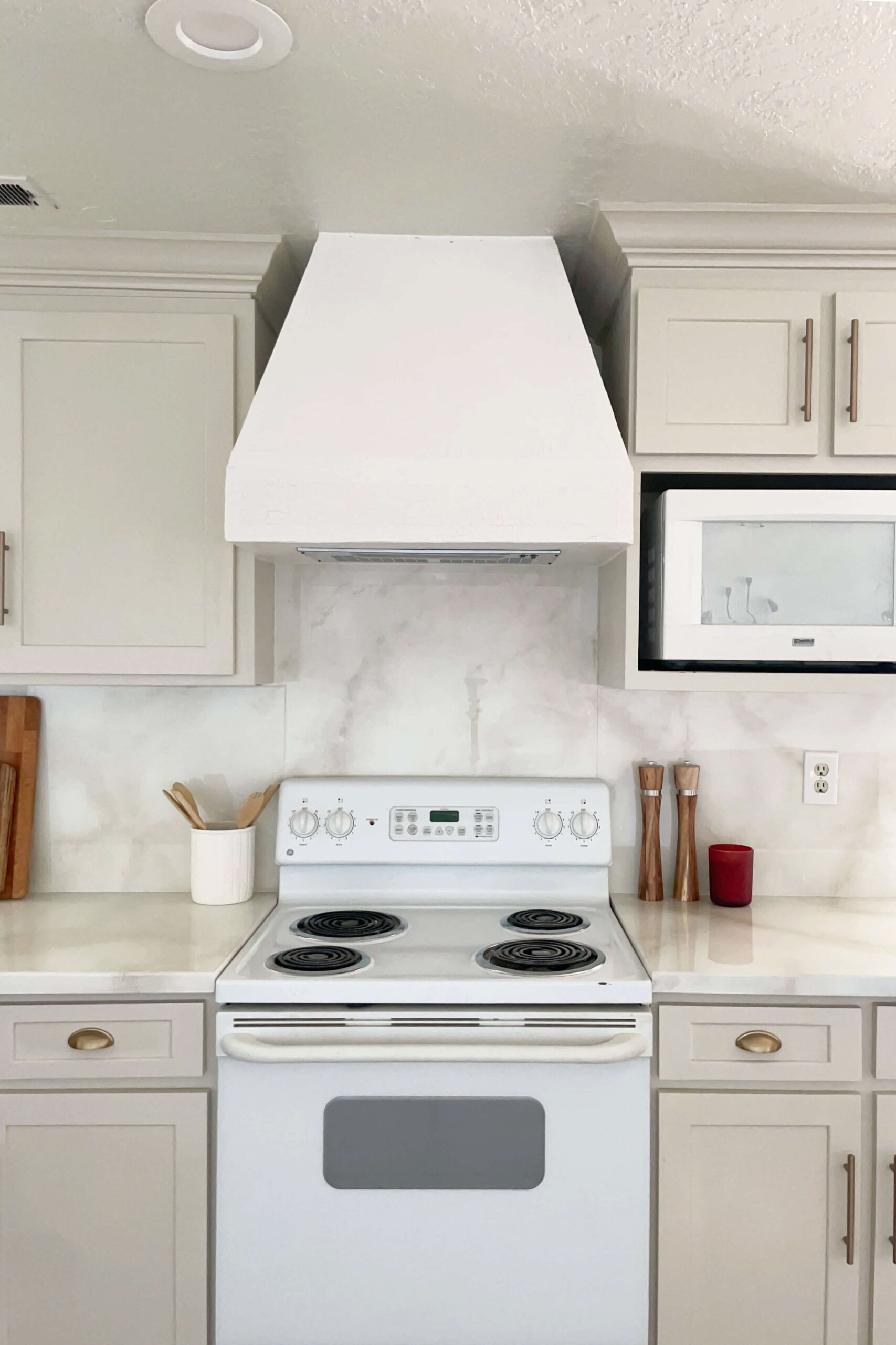 A finished picture of a venetian plaster range hood cover that I built during a budget kitchen remodel.