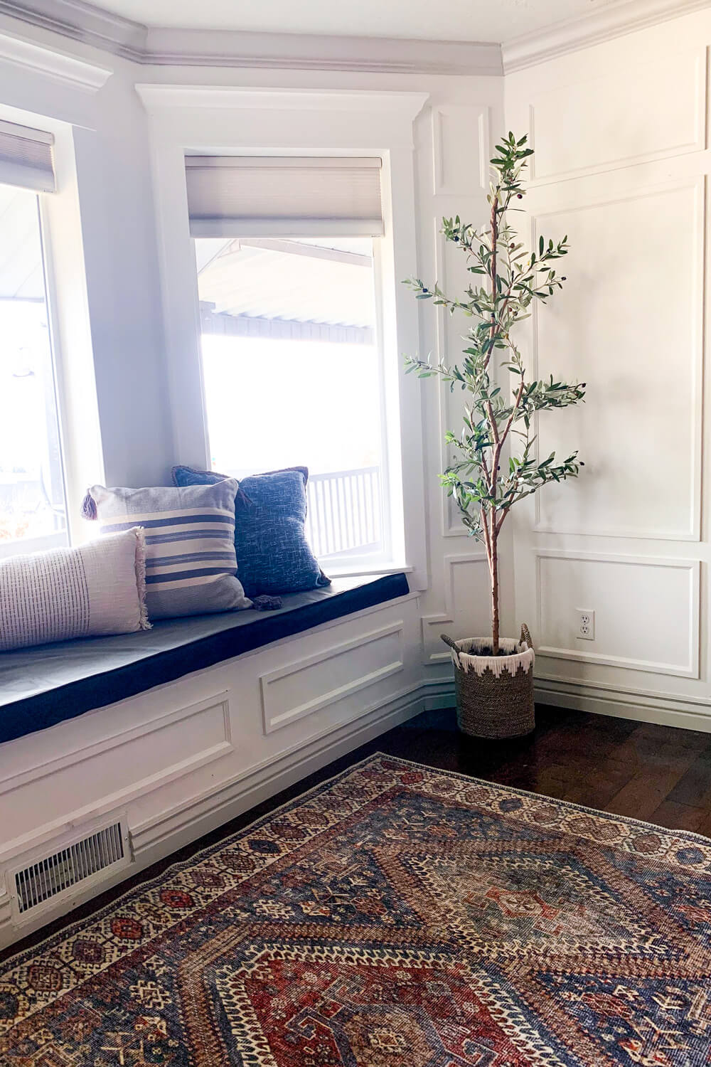 Finished bay window trim with classic picture frame molding.