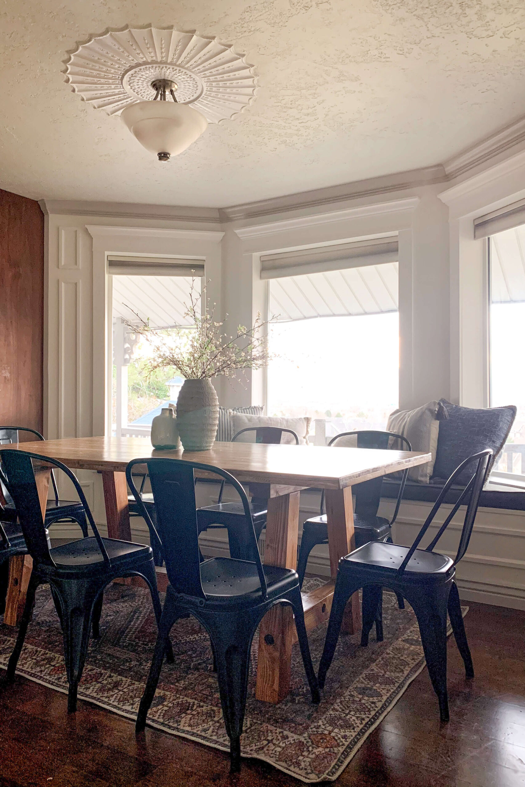 DIY kitchen table in a bay window dining nook. 