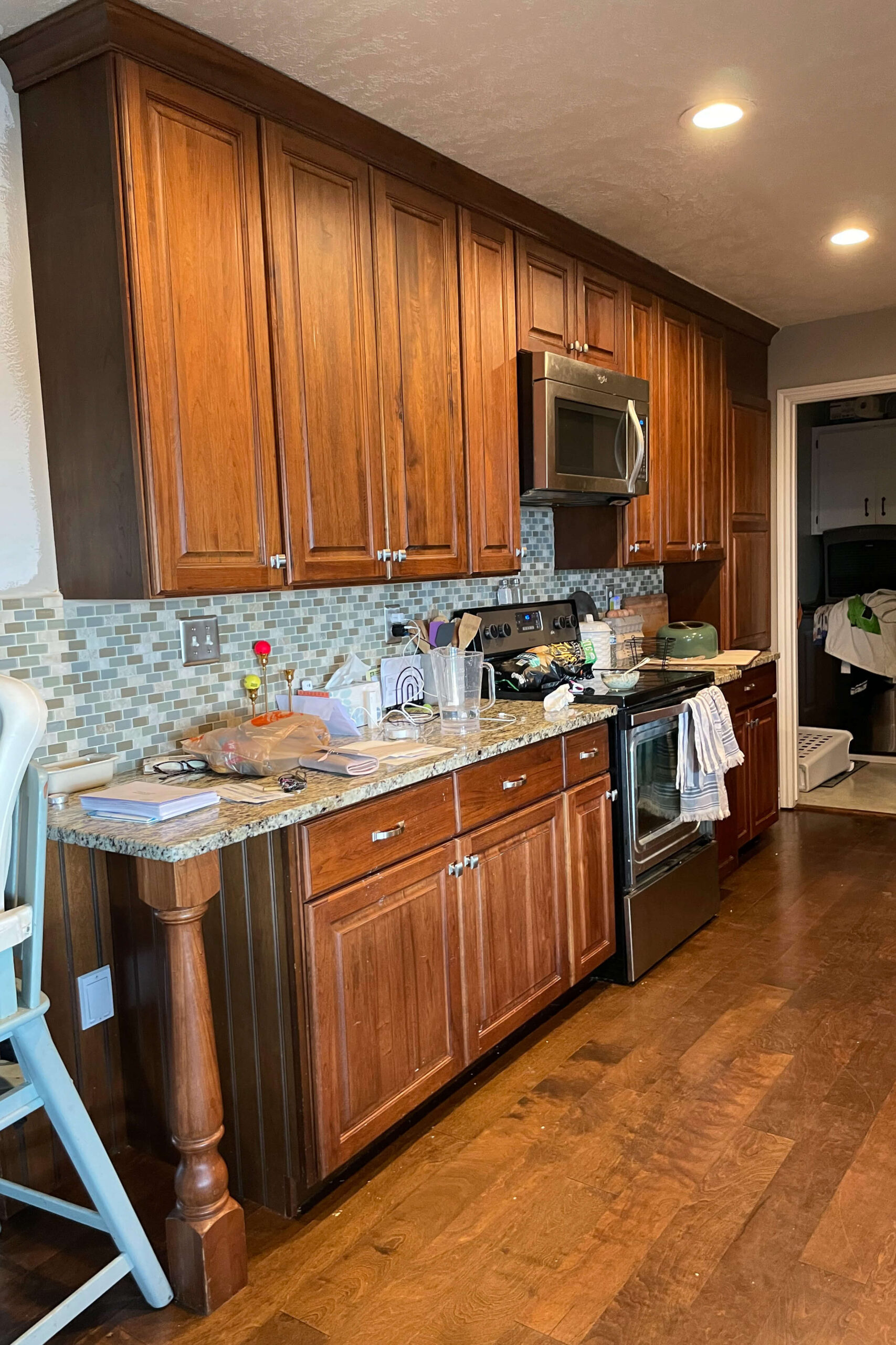 Before and after photos of kitchen cabinet painting.