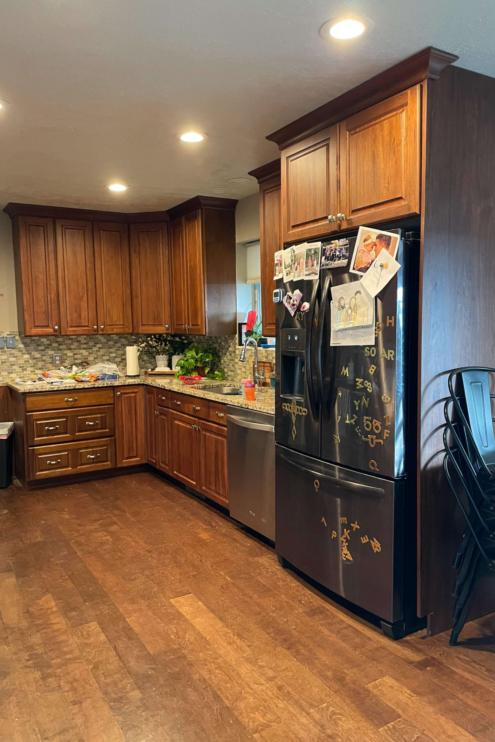 Before and after photos of kitchen cabinet painting.