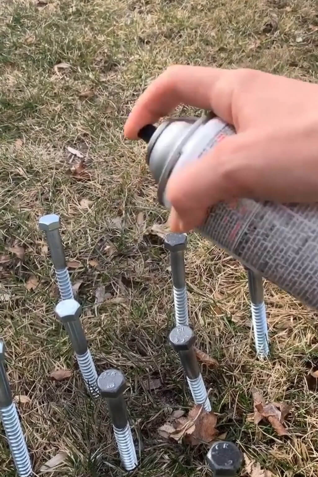 Spray painting lag bolts for a DIY table I built.