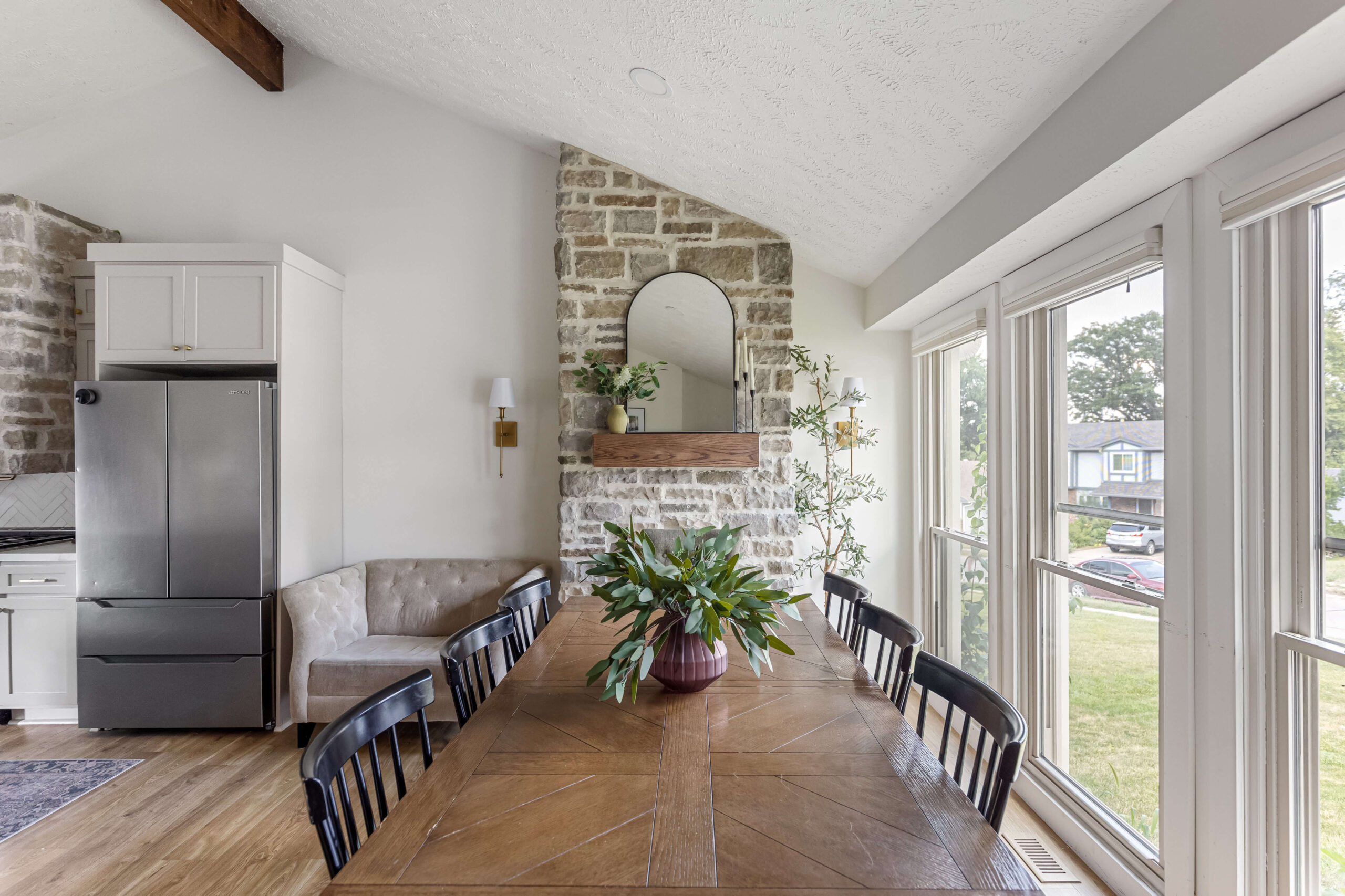 Floor to ceiling stone fireplace with wood beam mantel.