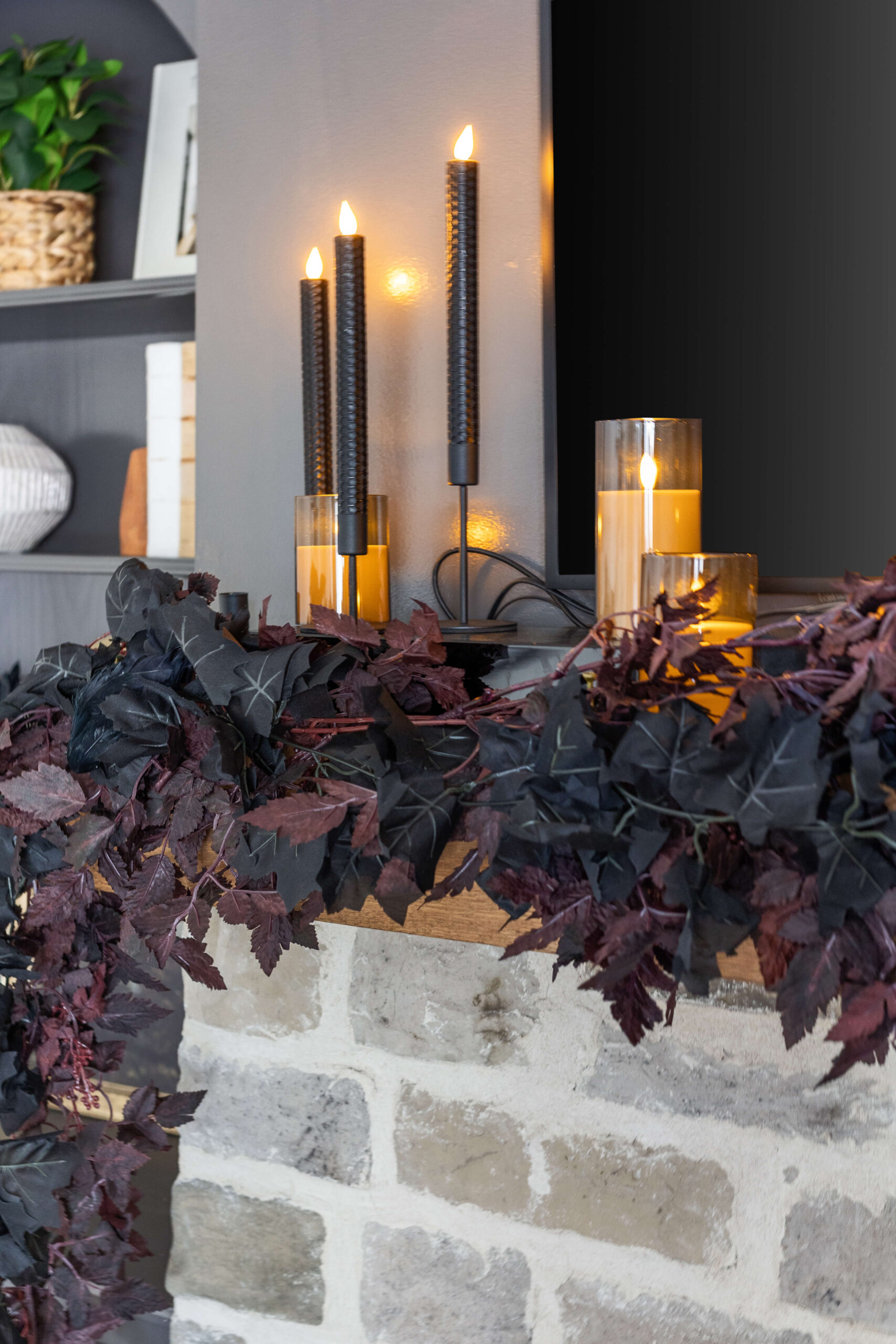 Layering two dark garlands for elegant Halloween decorating.