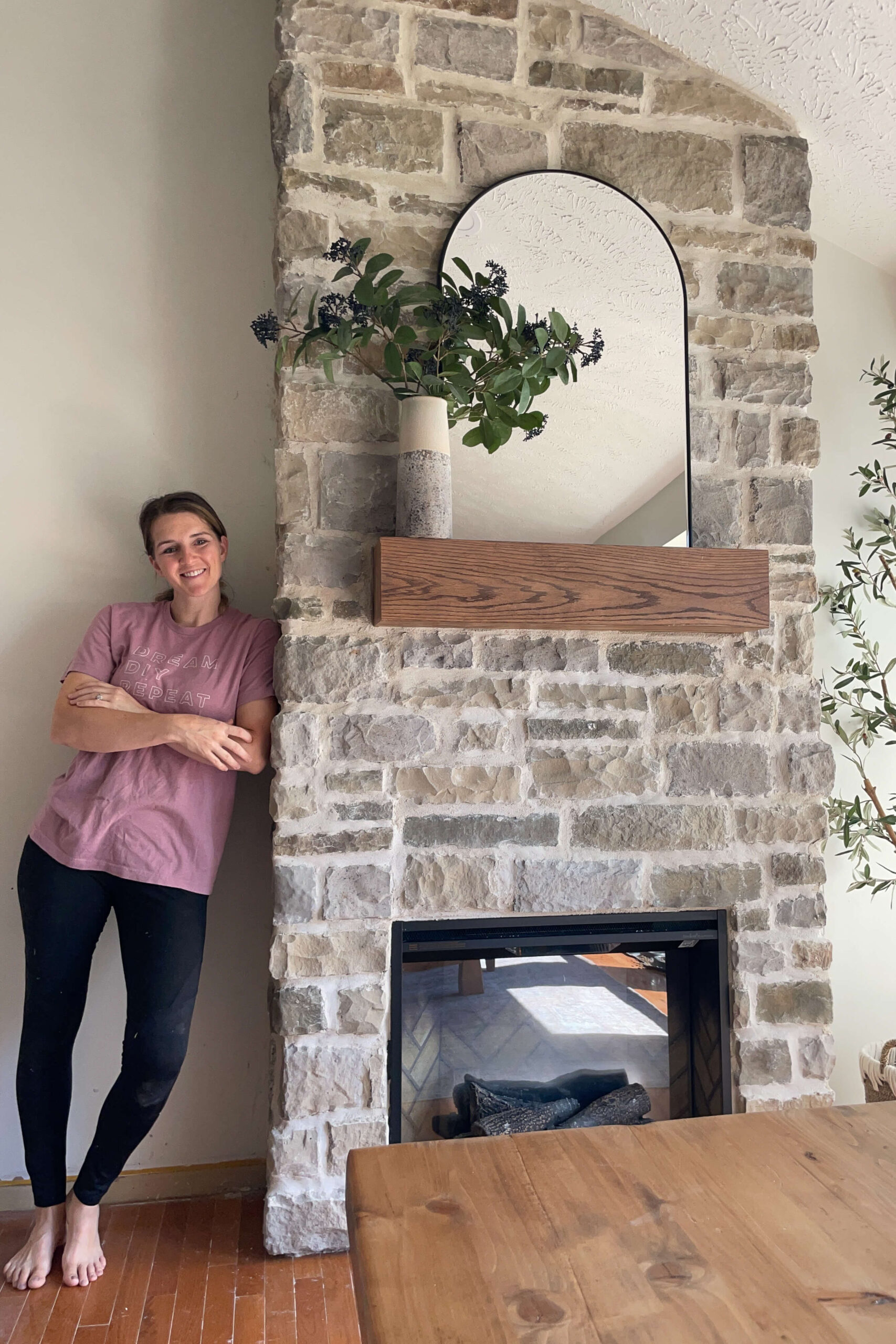 Completed DIY stone fireplace surround.