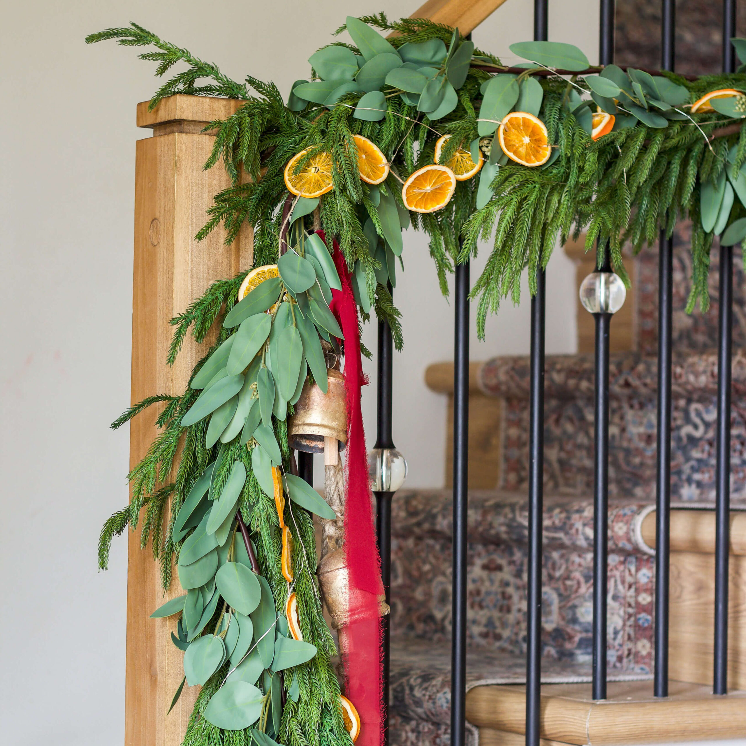 Gorgeous and realistic-looking Christmas garland on a staircase.