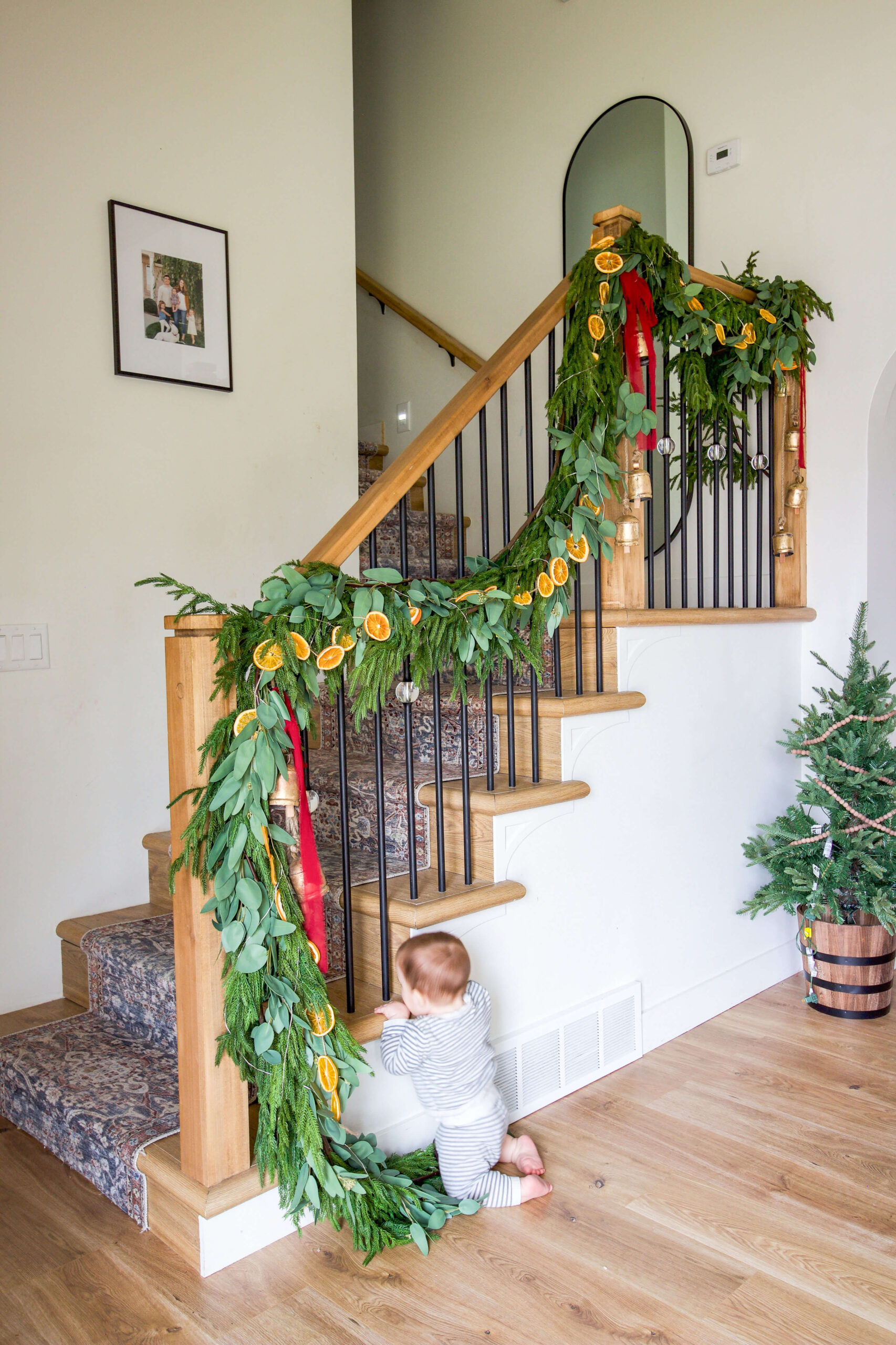 Gorgeous and realistic pine and eucalyptus garland on a staircase.