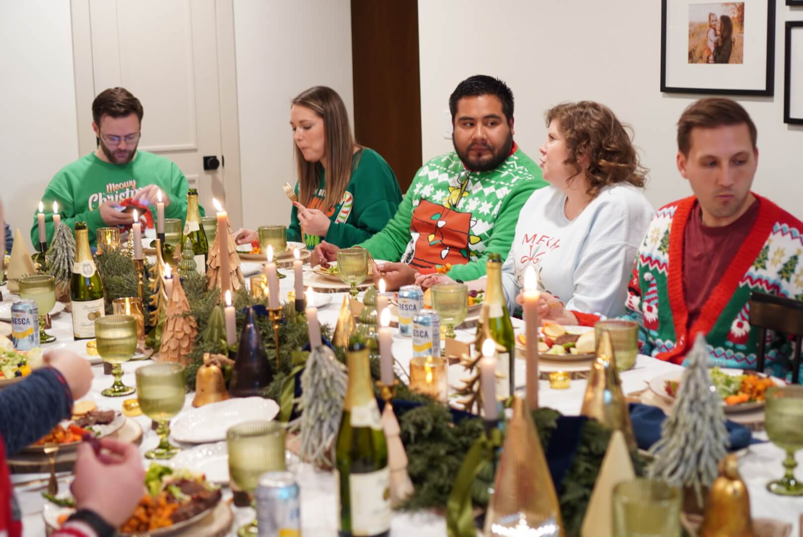 Guests enjoying Christmas dinner around a table with a Christmas tablescape