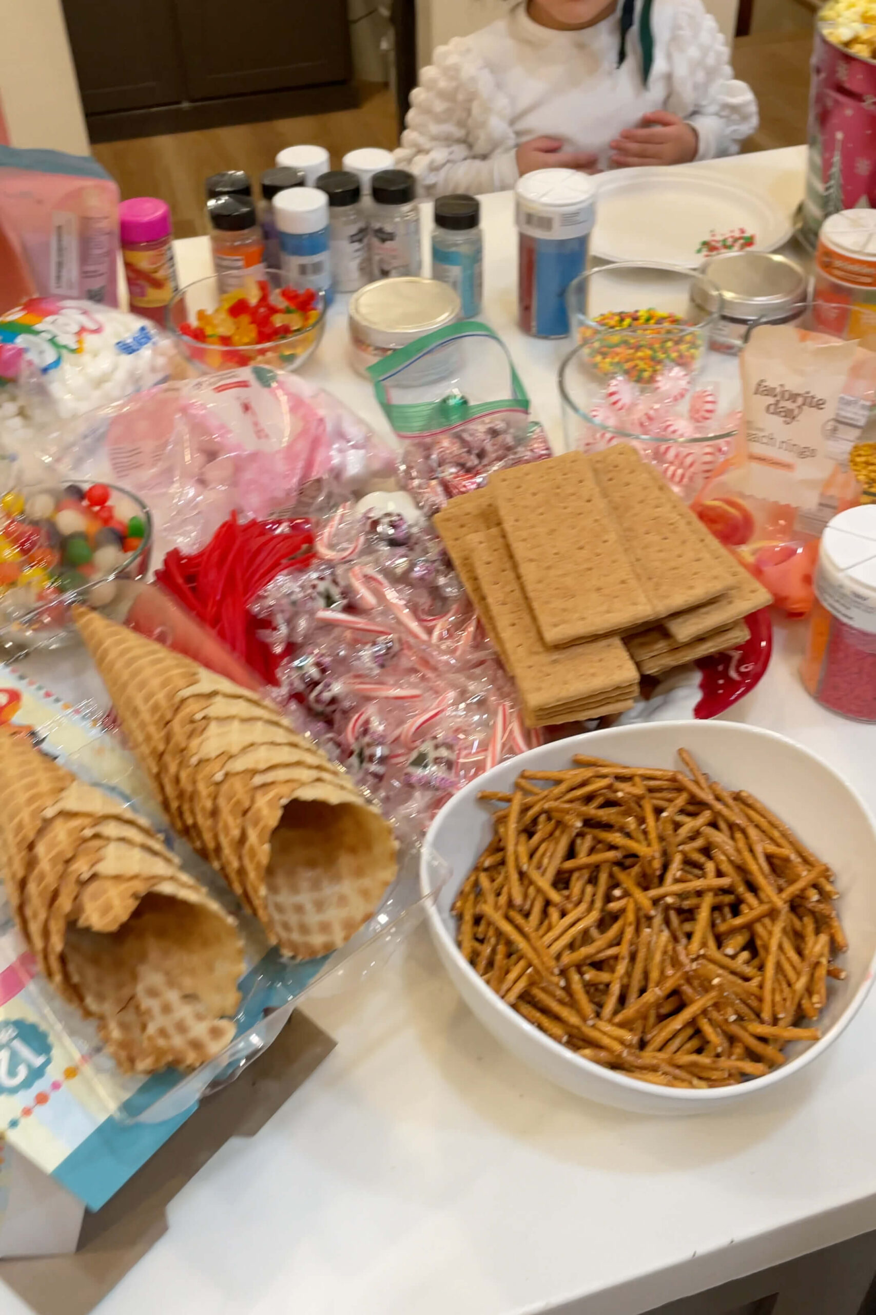 Ideas for what to bring to a gingerbread house decorating party.