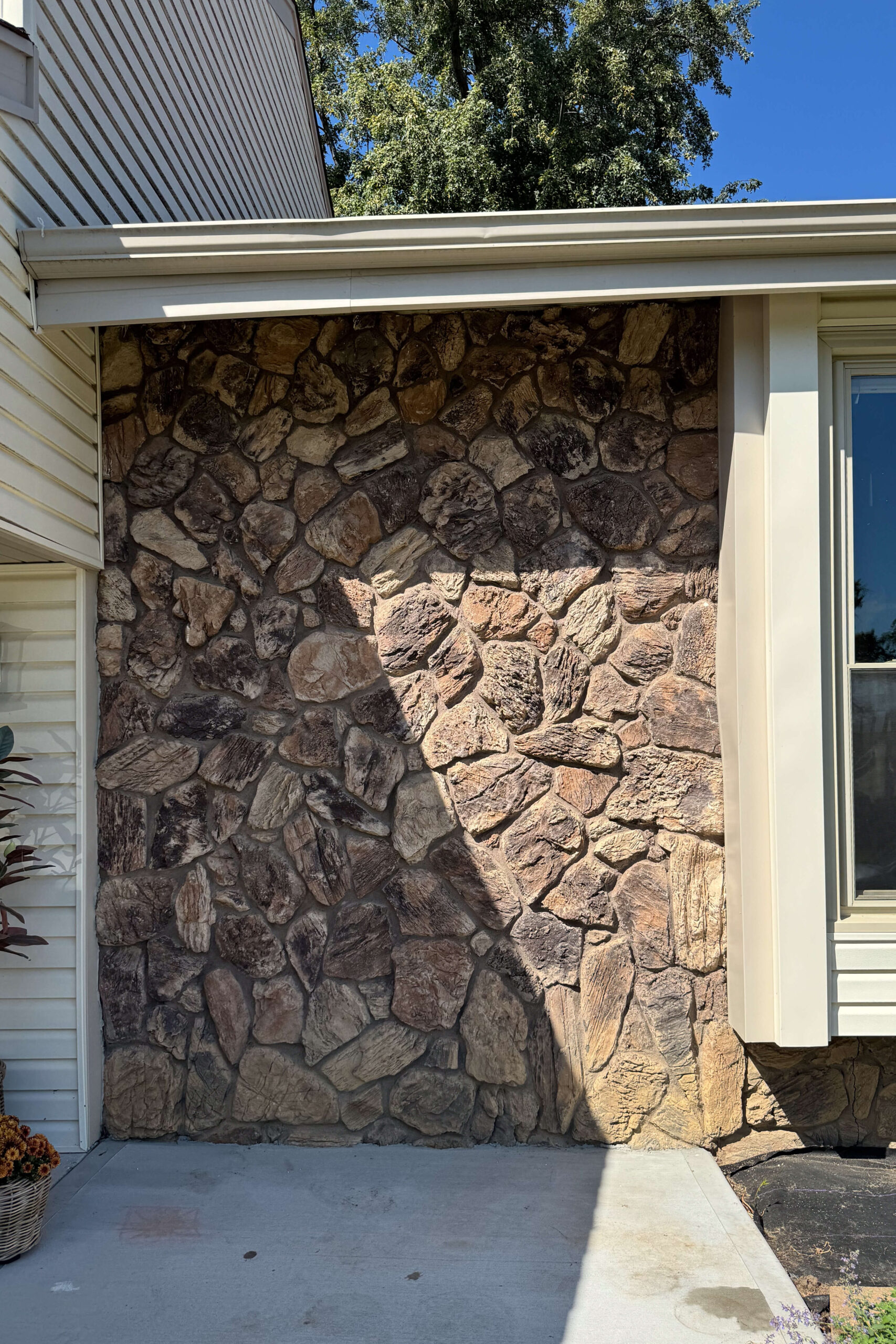 Before pictures of a dated 1970's rock exterior.