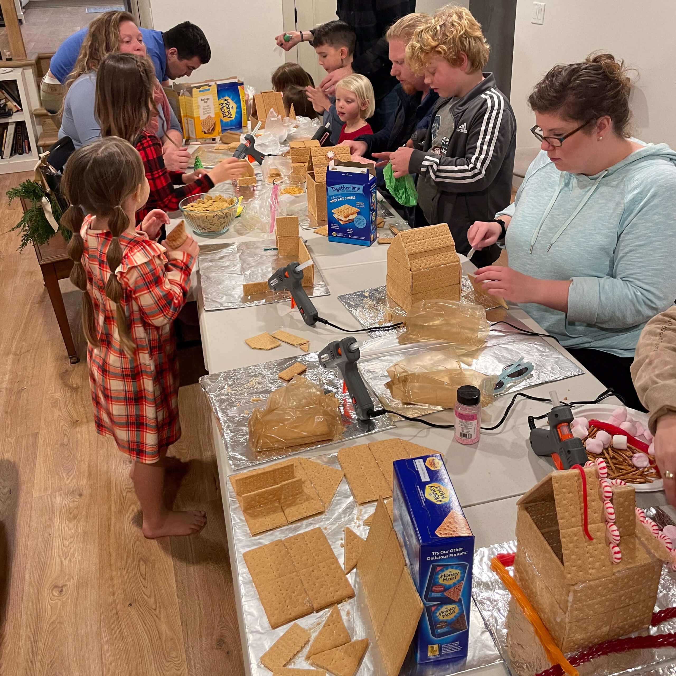 Everyone getting together for a decorating gingerbread house party.