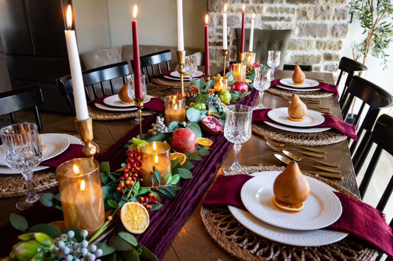 Thanksgiving tablescape with fall decor and candle centerpieces