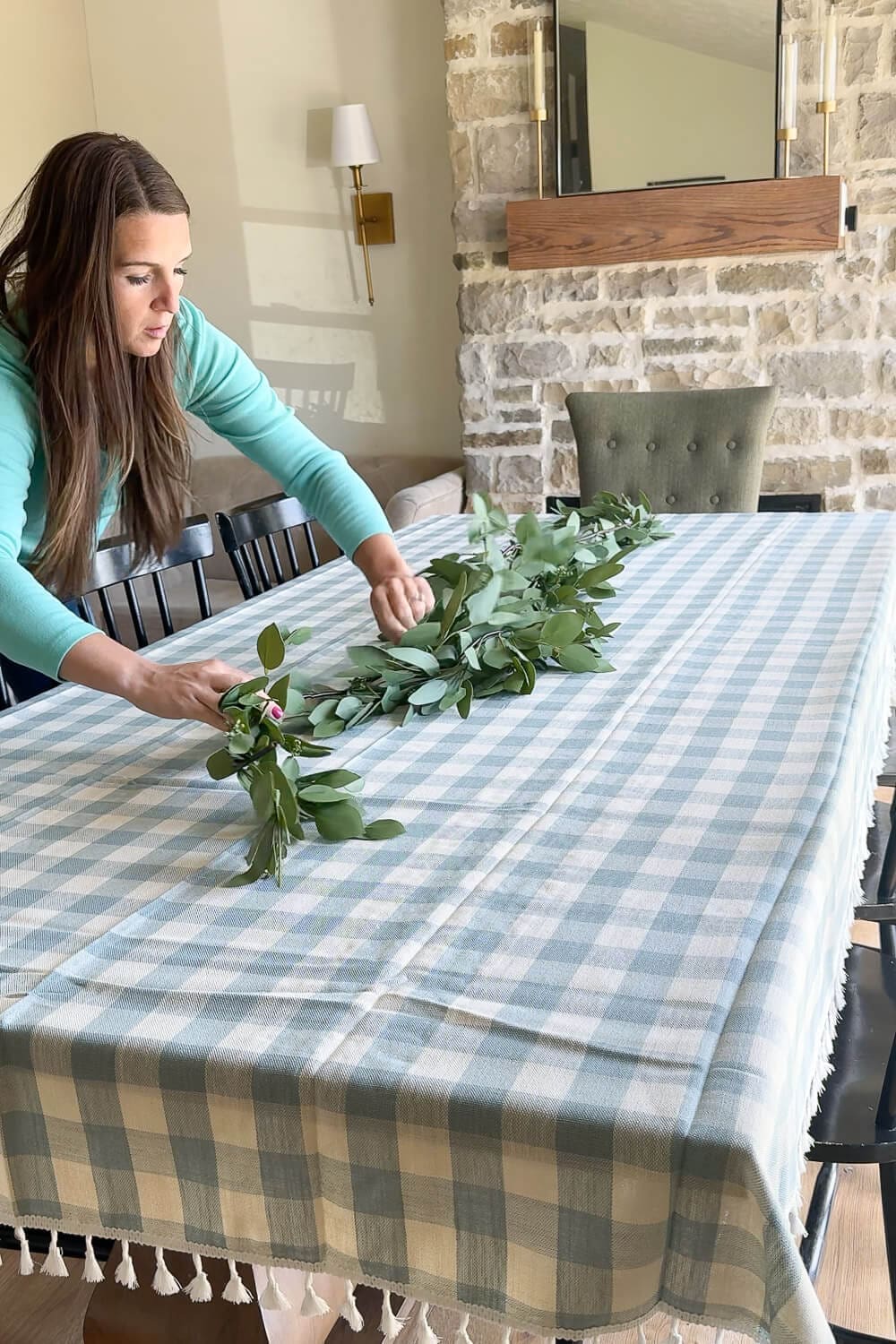 Easter table decorations featuring ceramic egg cups, speckled eggs, and pastel candles in glass holders