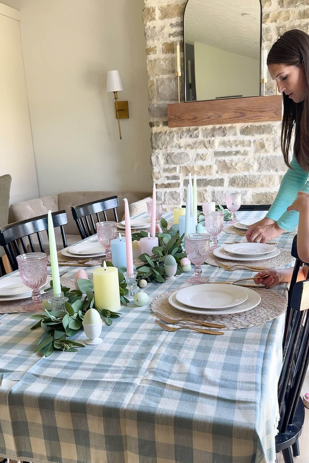 Easter dining table decor with blush lace napkins, gold napkin rings, and a pastel candle centerpiece