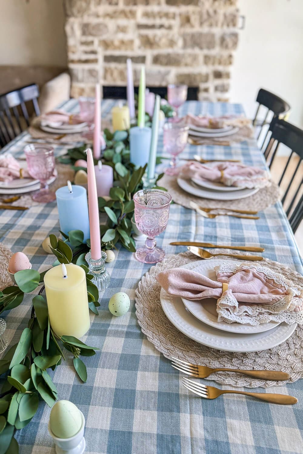 Step-by-step Easter table setup with pastel taper candles, lace napkins, and a blue gingham tablecloth