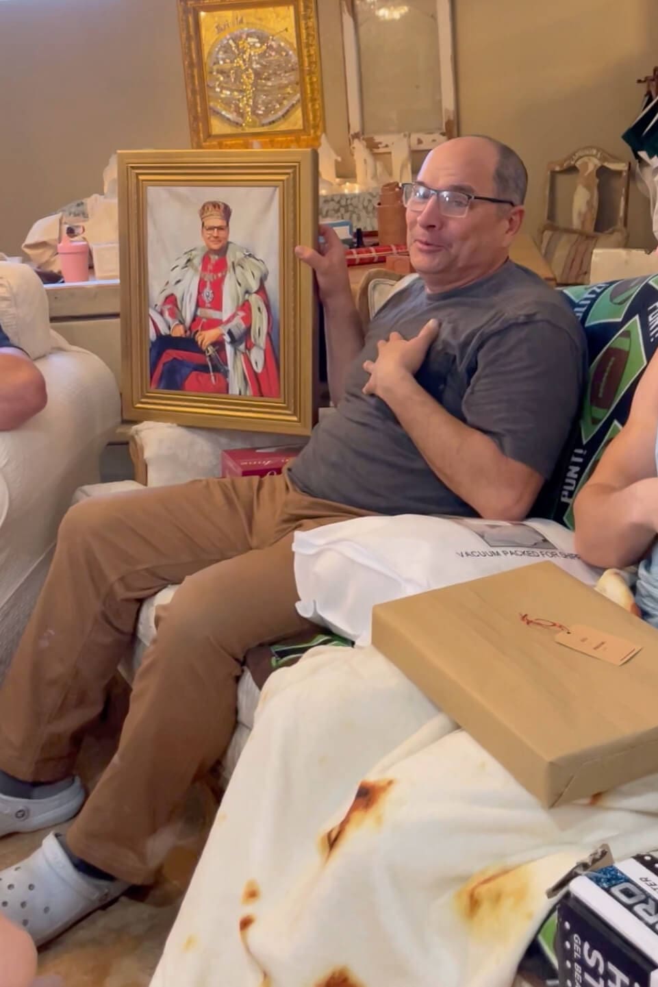 Proud father showing off a DIY canvas portrait gift in a gold frame on Father's Day.