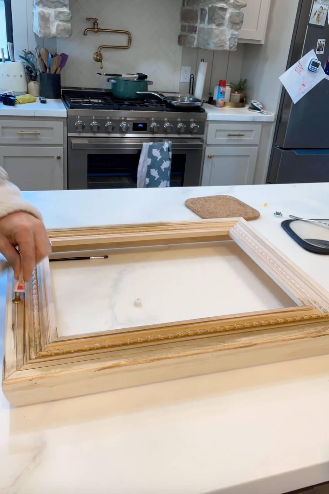 Beginning to apply Rub 'n Buff to a handmade wood picture frame as part of a DIY Father’s Day gift.