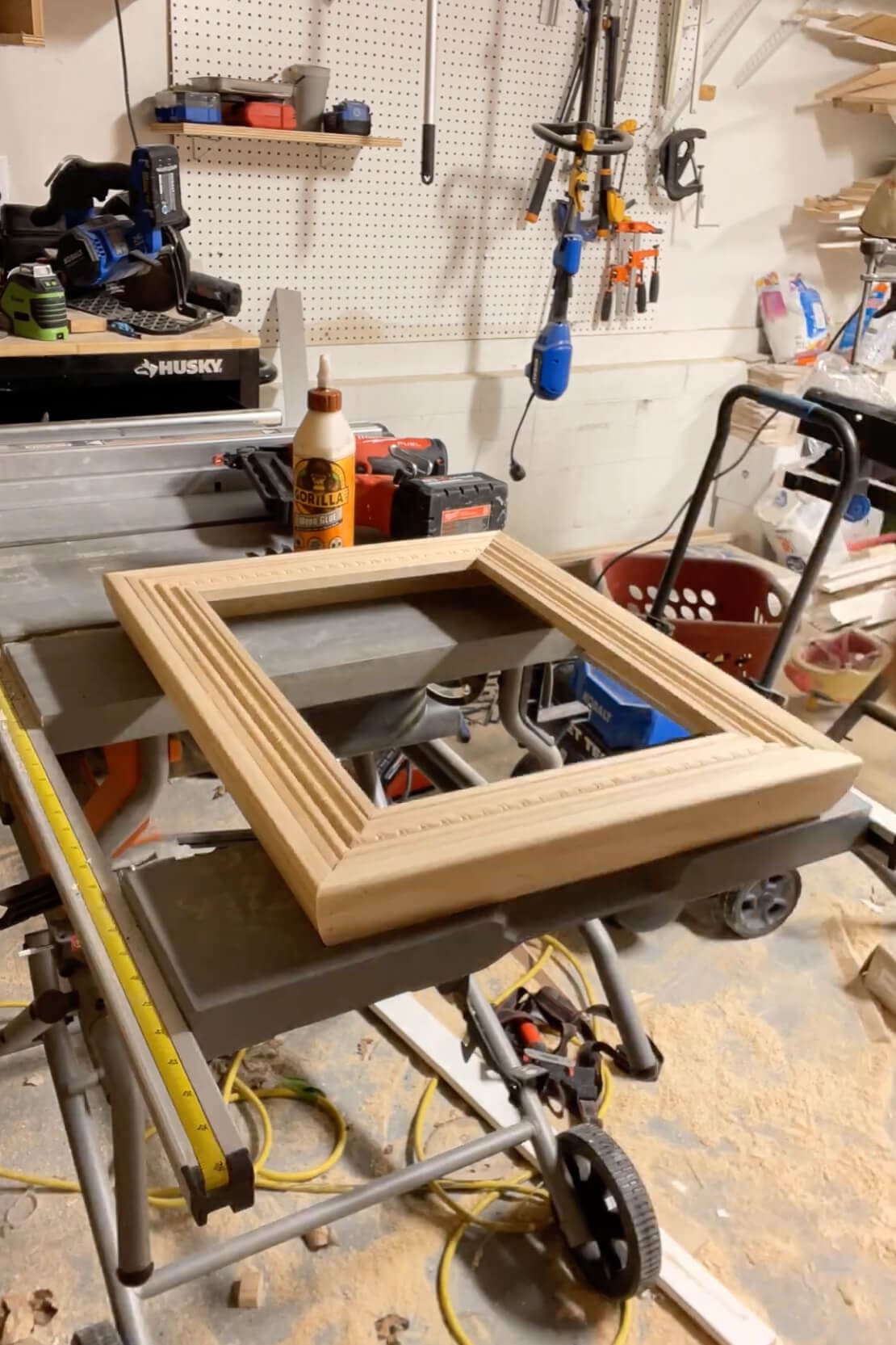 Completed raw wood picture frame on the workbench before painting and finishing.